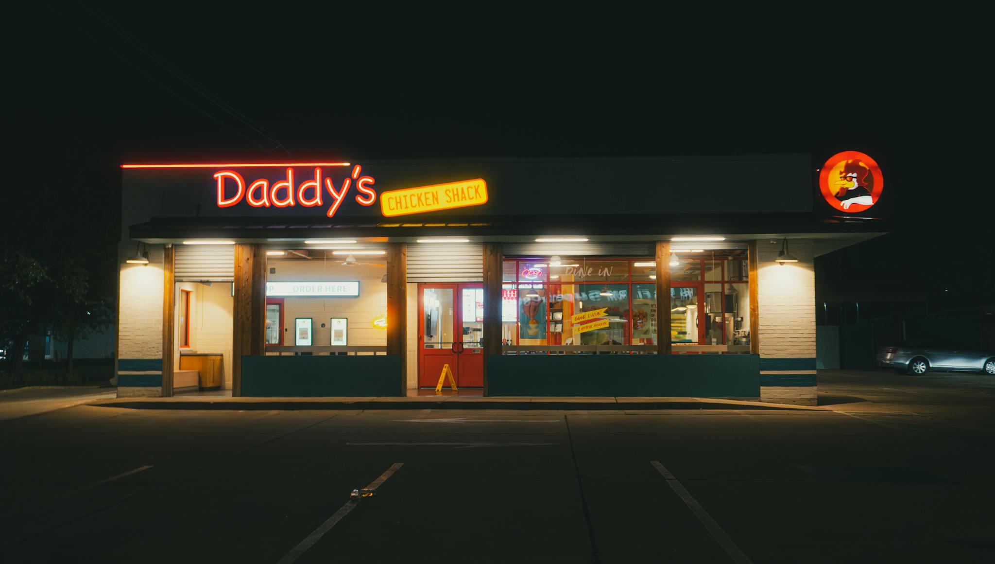 A fast food restaurant with neon lights at night in Houston, Texas.