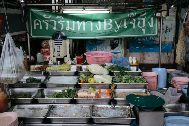 Colorful array of fresh ingredients at a Thai street food stall in Bangkok, showcasing culinary diversity.